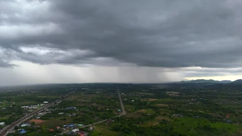 Straight highway cuts through Thai valley as massive stormfront approaches from Vídeo Stock 315225056