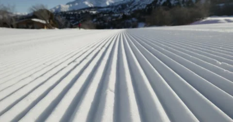 Straight line rows of freshly prepared groomed ski slope piste. Close-up shot Stock Footage 255885538