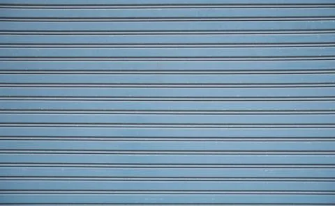 Straight lines or parallel lines of an iron door Rolling doors made of metal. 库存照片