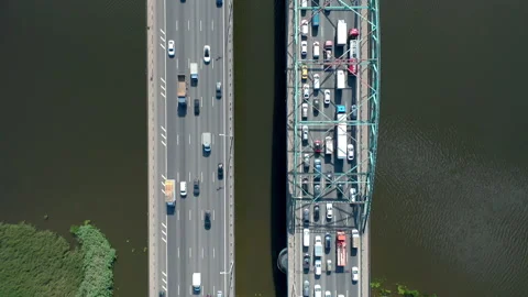 Straight motion across the double bridge with big traffic over river. Top down. Stock Footage 140815885