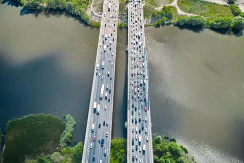 Straight motion through the double bridge with traffic over the river Stock Photos