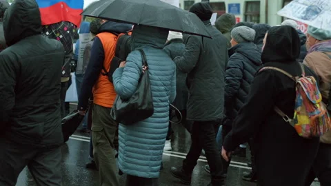 Straight picketing line of protesting people with flags and umbrellas in Russia. Stock Footage 154430411