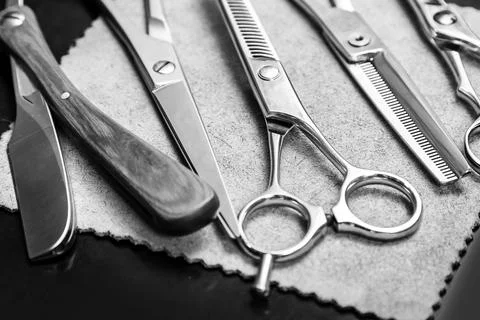Straight razor and different scissors Stock Photos