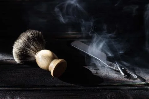 Straight razor and shaving brush on a luxury wooden background Stock Photos