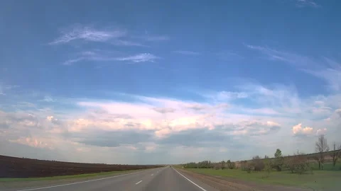 Straight road, sky with clouds horizon. Behind wheel. Car trip with beautiful Stock Footage 243534070