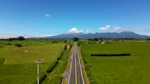 Straight road to snow capped Mt Taranaki / Egmont Stock Footage 259854487