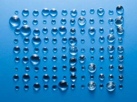 Straight rows of a drop of water on a blue background in the form of a rectangle Stock Photos