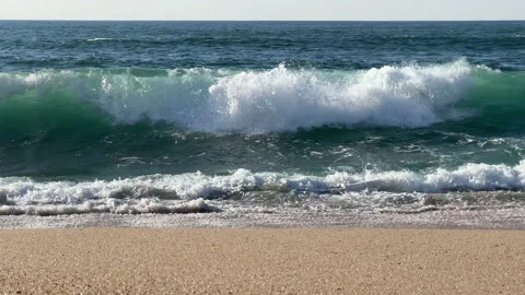 Straight view of waves breaking on the shore of beach on sunny day in spring Stock Footage 237754717