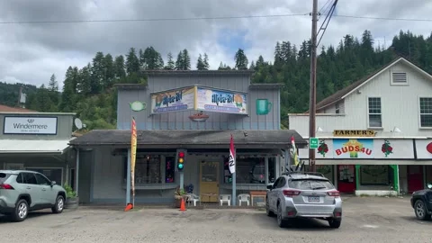 Straight on wide shot of the store Alpha Bit in Mapleton, Oregon. Rural Stock Footage 159844872