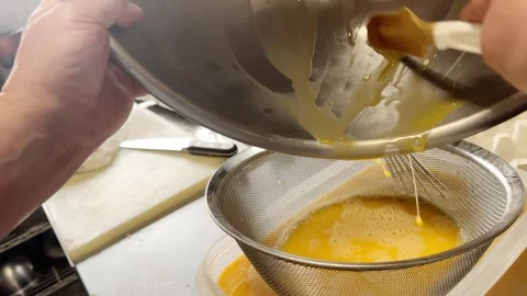 Straining Beaten Eggs Through a Fine Sieve for Japanese Dashimaki, Japan Stock Footage 340781338