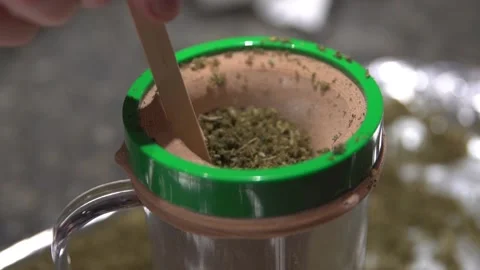 Straining Dry Herb In A Mason Jar With Muslin Cloth And A Wooden Stick - Stockbeeldmateriaal 137479713