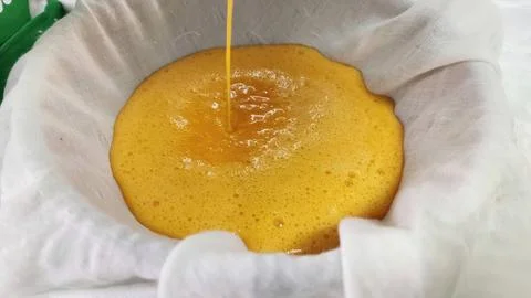 Straining Egg Yolk Mixture through White Cheesecloth for Thai Dessert Stock Photos