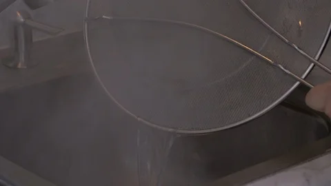 Straining Hot Water Through Mesh Splatter Guard Stock Footage 97780039