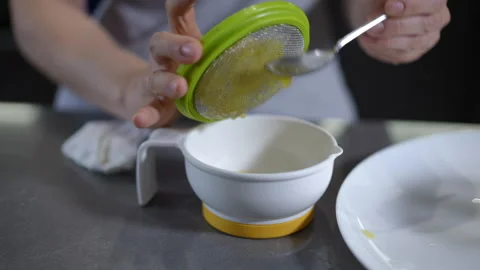Straining ingredients is essential for achieving excellence in a modern kitchen Stock Footage 301438004