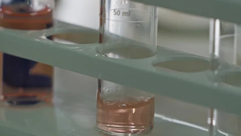 Straining the liquid through the filter into the glass laboratory miracle. Stock Footage 308506352