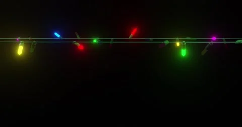 Strand of coloured christmas string lights flashing on black background, copy Stock Footage 253158394