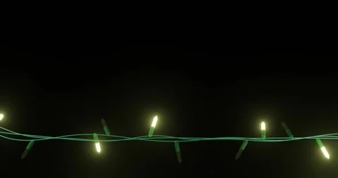 Strand of yellow christmas string lights flashing on black background, copy Stock Footage 253158444