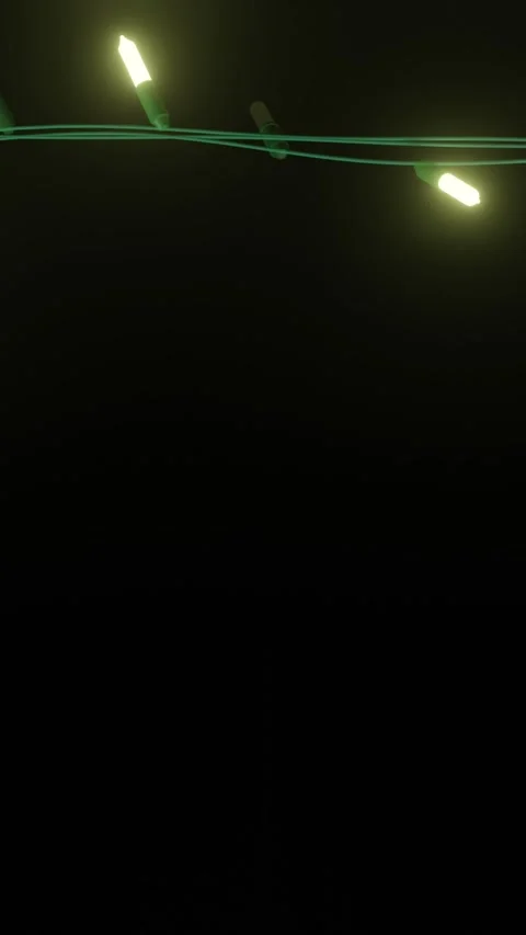 Strand of yellow christmas string lights flashing on black background, copy Stock Footage 343641289