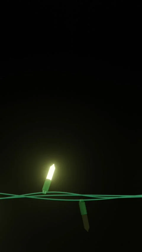 Strand of yellow christmas string lights flashing on black background, copy Stock Footage 343641290