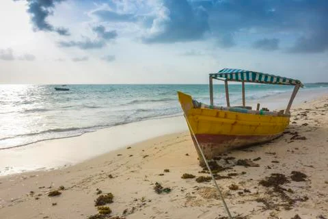 Stranded boat on a tropical beach Stock Photos