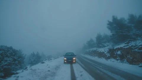 Stranded Car car in snow blizzard in foggy Forest mountain Road Stock Footage 124499795