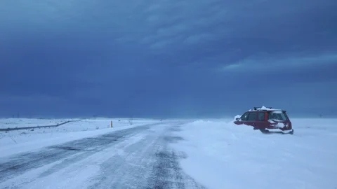 Stranded car on side of road after snow storm Iceland winter Stock Footage 102517852