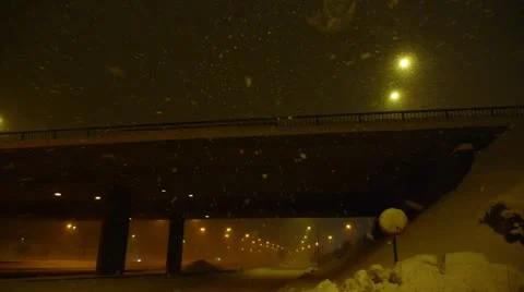 Stranded at the side of a highway one winter night while snow flakes fly past Video stock 12713643