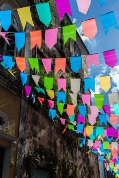 Strands of St. Johns Day flags and an old mansion Stock Photos