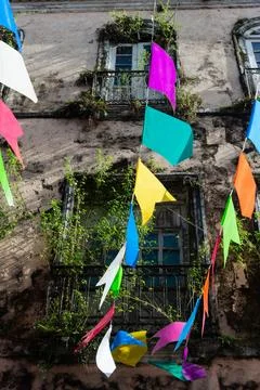 Strands of St. Johns Day flags and an old mansion Stock Photos