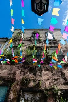 Strands of St. Johns Day flags and an old mansion Stock Photos