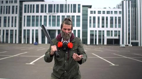 Strange bearded middle-aged man in parking bangs bat on his palm Stock Photos
