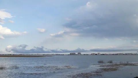 Strange Clouds moving over coastal town Stock Footage 84045007