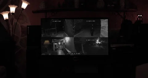 Strange Ghost Figure On Scary Security Cameras On TV Stock Footage 207136979