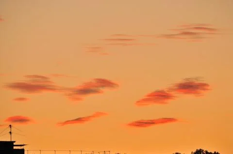 Strange orange clouds at sunset Stock Photos