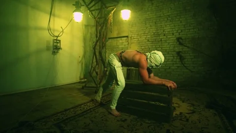 Strange strong man doing handstand Stock Footage 77993968