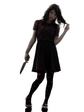 Strange young woman killer holding  bloody knife silhouette Stock Photos