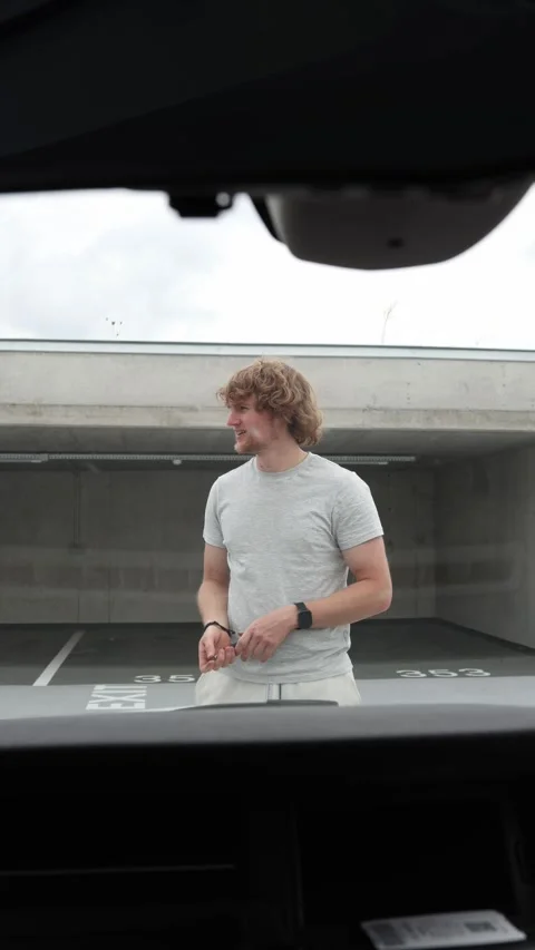 Stranger scratches a parked car with a sharp object and leaves the garage Stock Footage 342919123