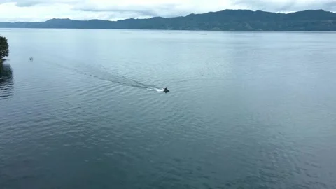 A stranger using a fast boat on the lake Stock Footage 213920896