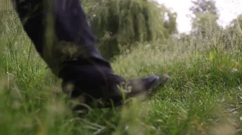 Stranger, walking on the grass 3 Stock Footage 32476559