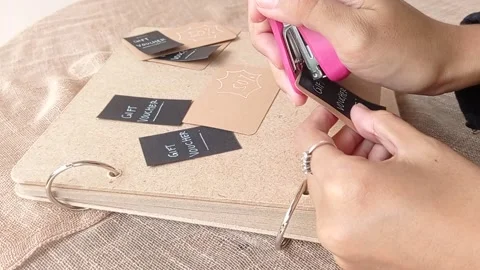 Strapping a blank paper with an orange strapler Stock Footage 146258459