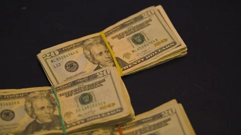 Straps of Cash Thrown onto a Table Stock Footage 94159272