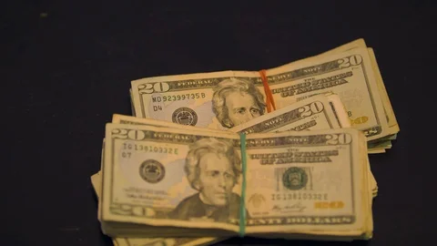 Straps of Cash Thrown onto a Table Stock Footage 94159324