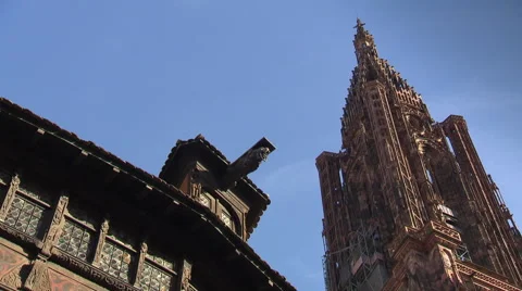 Strasbourg cathedral tower with roof of medieval house in front Stock Footage 59311947