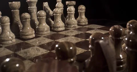 Strategic Chess Moves Captured in Elegant Marble Pieces and Board Stock Footage 338141014