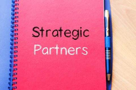 Strategic partners write on notebook Stock Photos