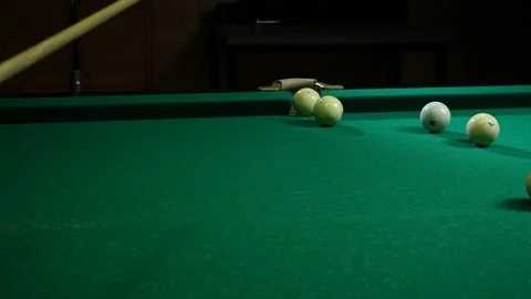 Strategy and sucess concept. Game of pool billiards. Close-up on the cue that Stock Footage 240738095