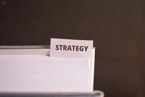 Strategy Paper Tab Between Book Pages for Leadership, Decision Making and G.. Fotos Stock