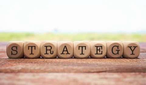 Strategy word written on cube shape wooden blocks on wooden table.  Stock Photos