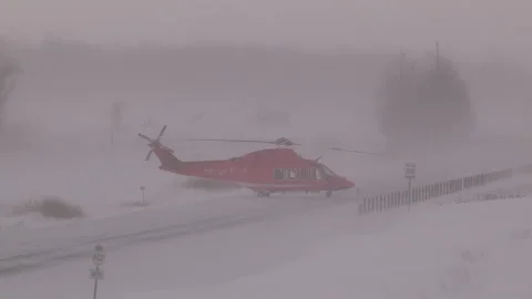 Strathroy, Canada Feb 11 2014 Ambulance helicopter in snow storm on highway Stock Footage 335721068