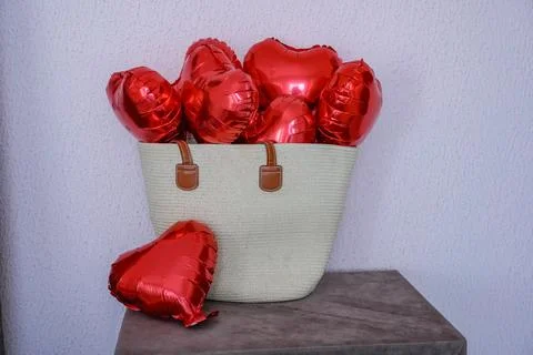 Straw Bag with Heart Balloons Stock Photos